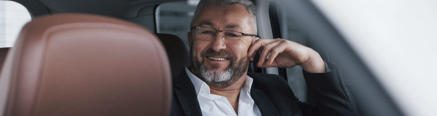 Business man riding in back seat